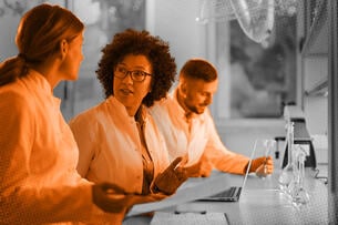 Photo illustration of scientists reviewing documents